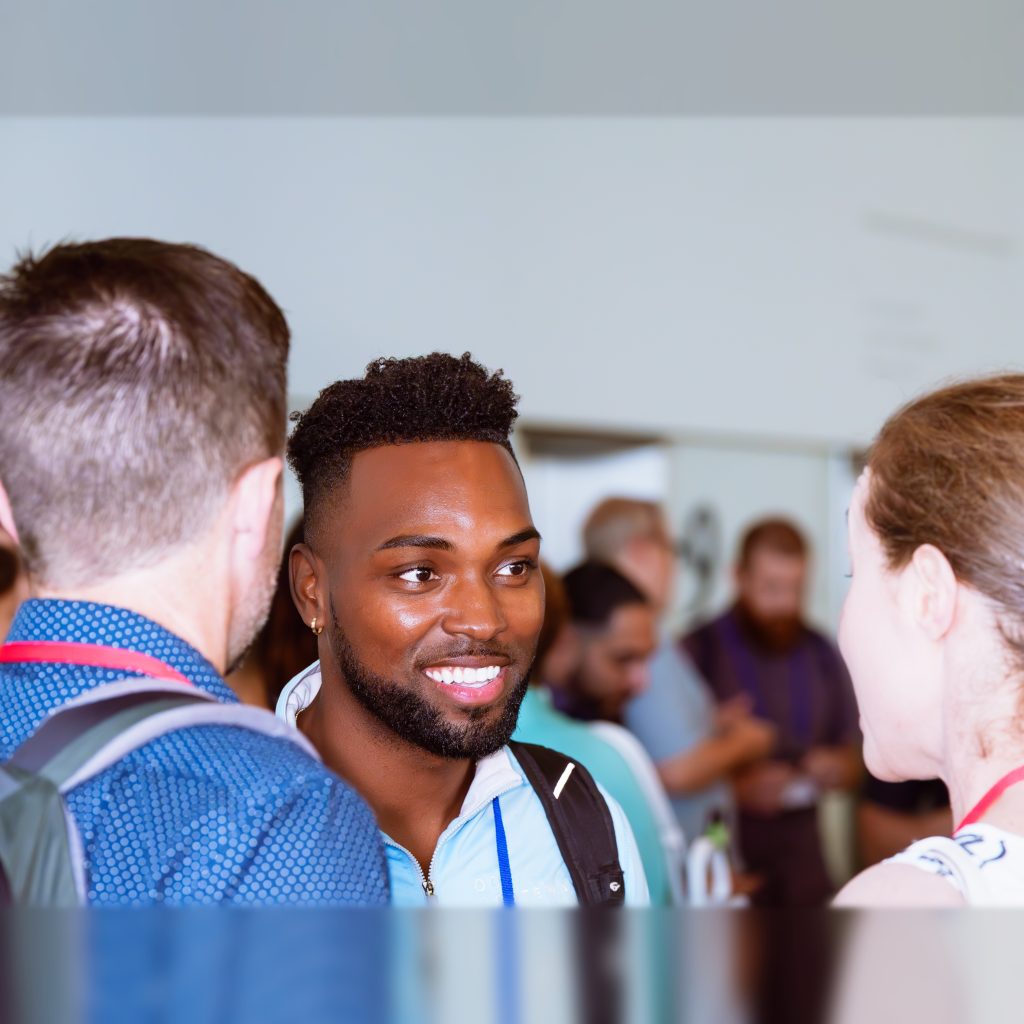Gateway Capital team member Lamarr Banks speaking with colleagues at a networking event