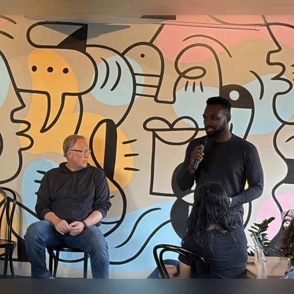Gateway Capital team member speaking into a microphone at a community panel event